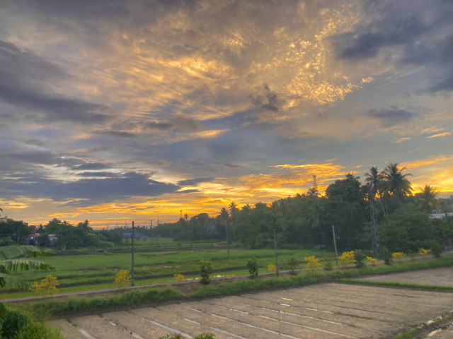 The setting sun coloring the clouds with the beauty of a beautiful valley.