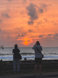 People capturing the sunset