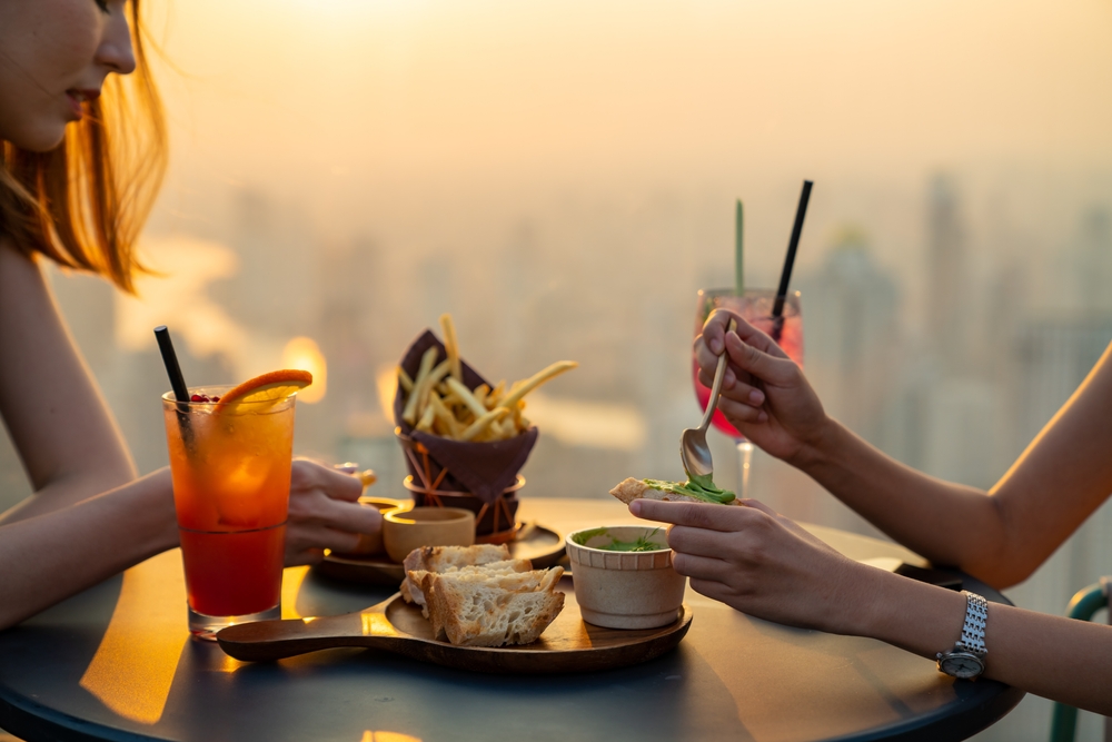 Rooftop restaurant bar in metropolis at summer sunset