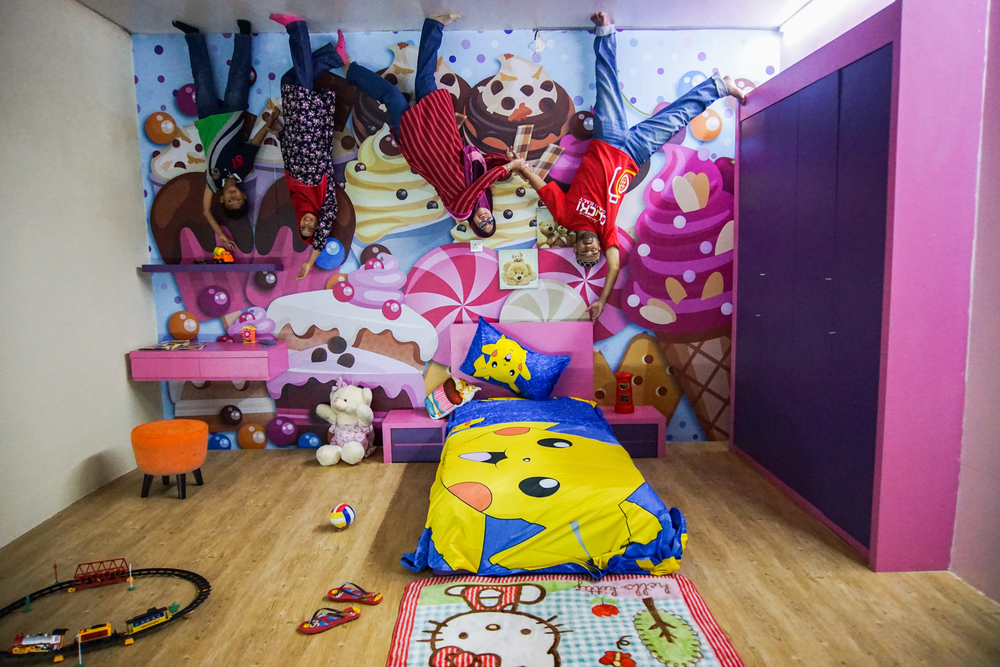 Family of Malaysia enjoying holidays at upside down in Malacca ,Malaysia.