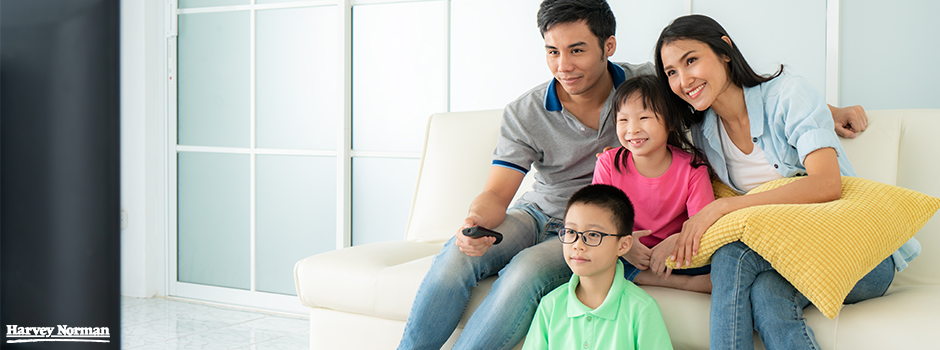 Family watching movie at home with soundbar