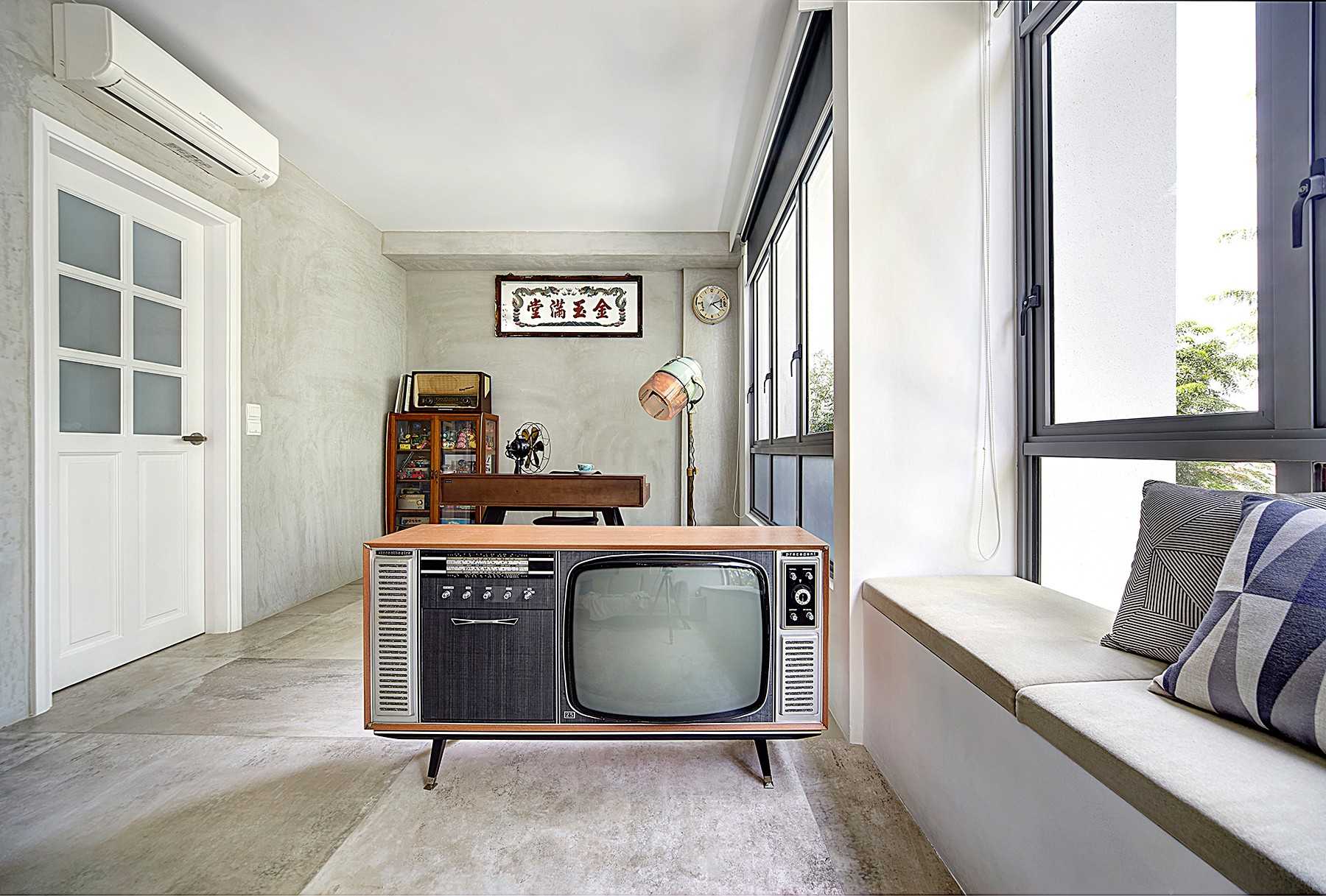 Vintage Living Room with Cement Floor and Bay Window