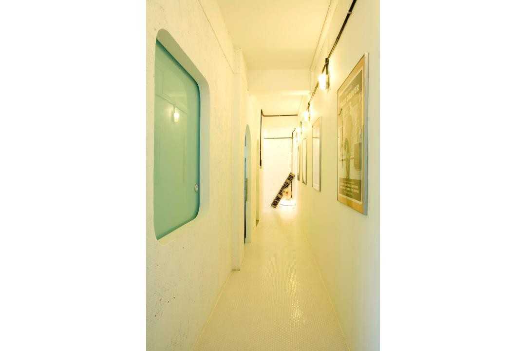 Eclectic Hallway with Artwork and Lighting