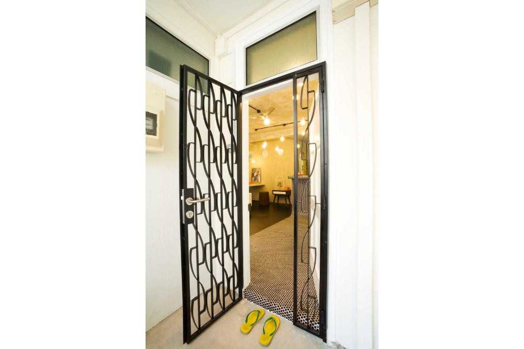 Eclectic Entryway with Drop Light and Metal Gate