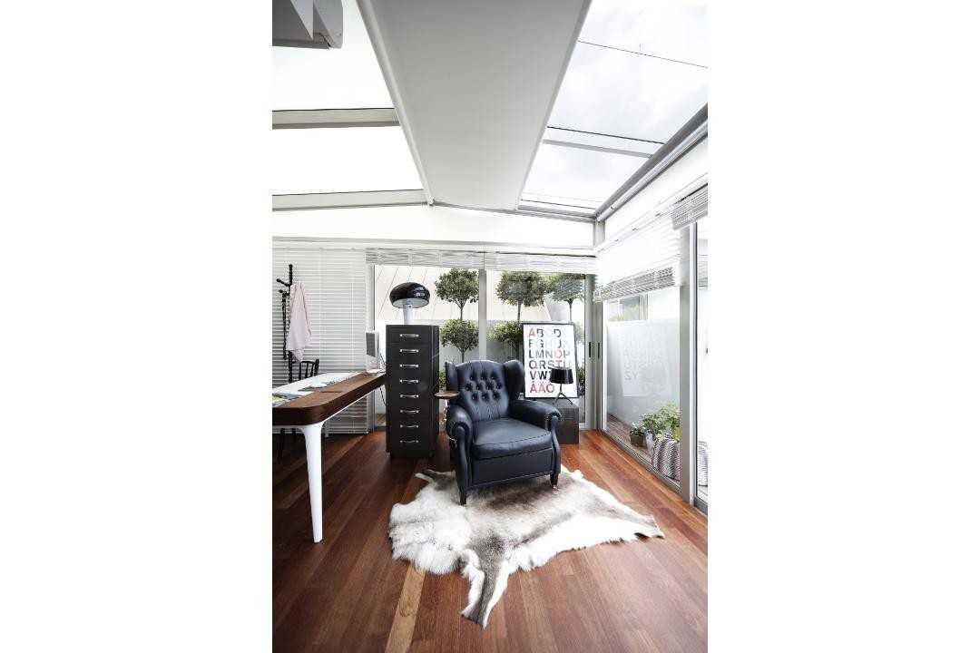 Eclectic Study with Wood Flooring and Armchairs