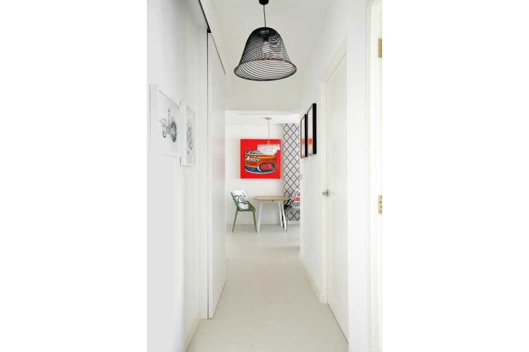 Transitional Hallway with Paintings and Lighting