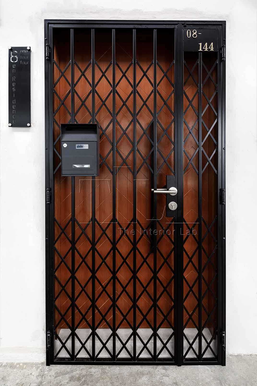 Industrial Entryway with Herringbone Tiling and Metal Gate