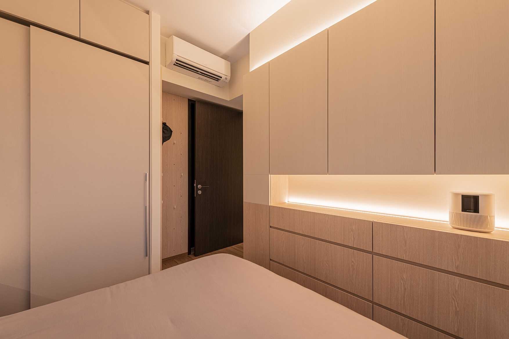 Minimalist Bedroom with Wood Flooring and Ceiling Light