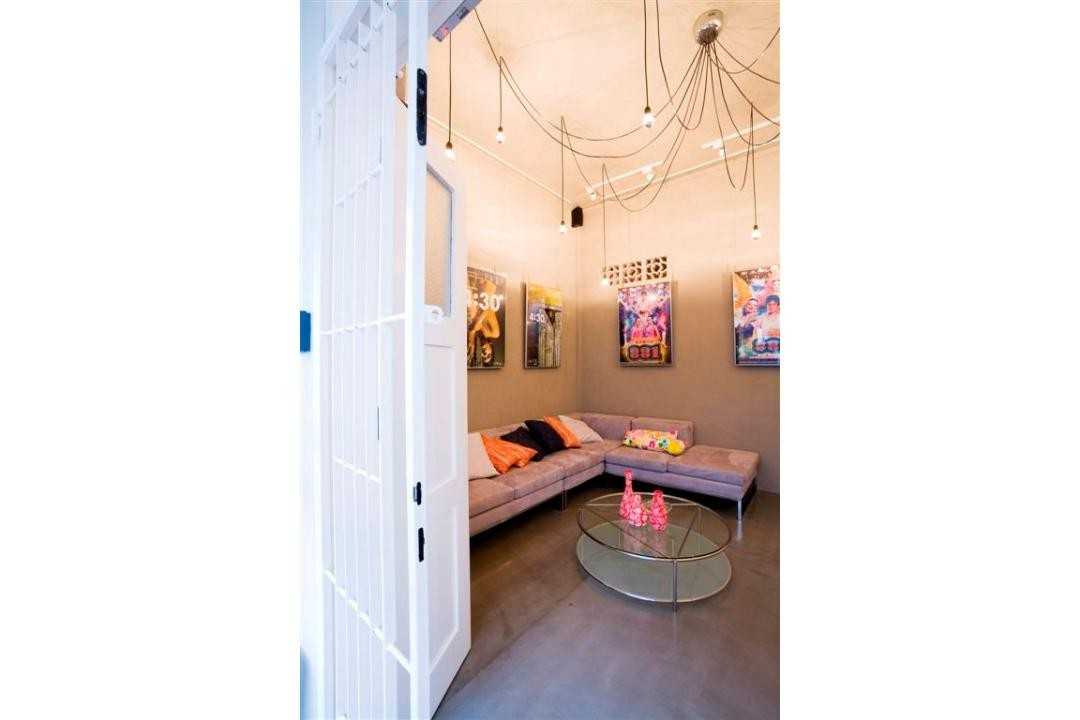 Eclectic Shopfront with Cement Floor and Drop Light