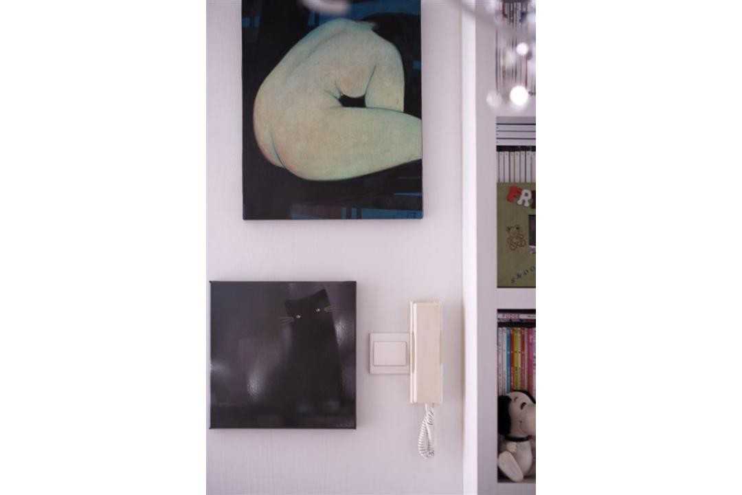 Eclectic Entryway with Bookshelf and Paintings