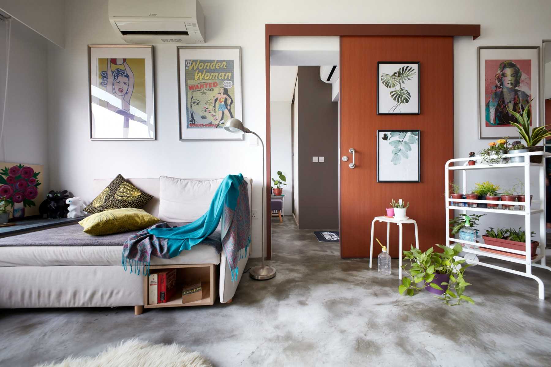 Eclectic Living Room with Cement Floor and Paintings