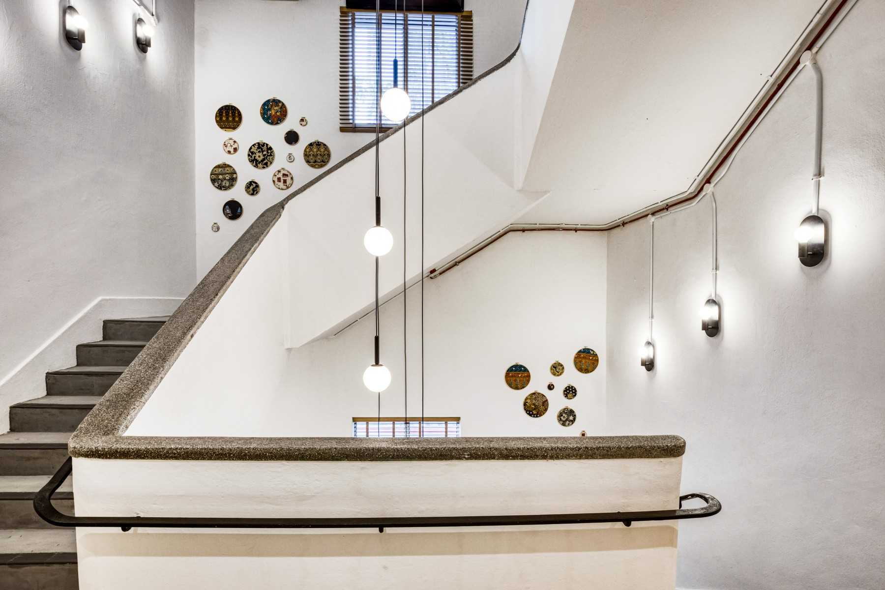 Transitional Hallway with Drop Light and Staircase