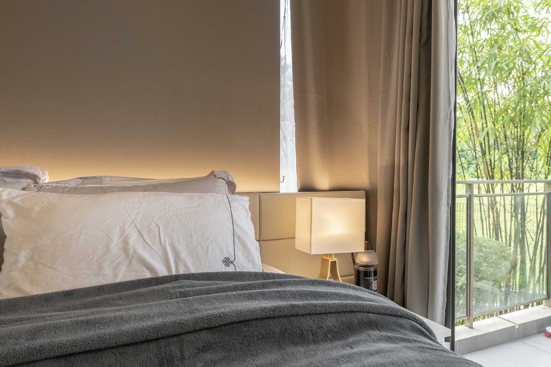 Modern Bedroom with Parquet Floor and Bedside Table