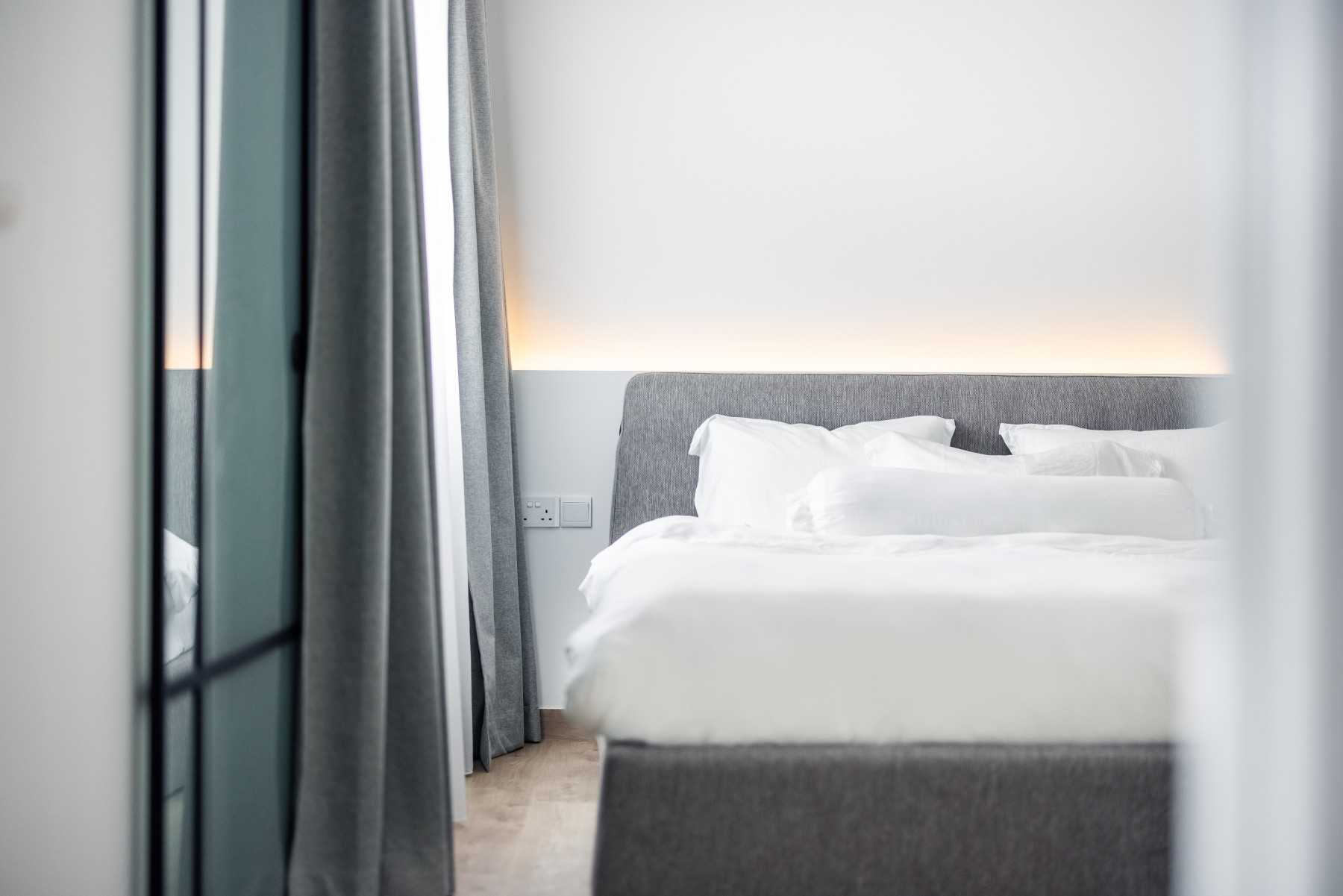 Minimalist Bedroom with Vinyl Flooring and Cove Lighting