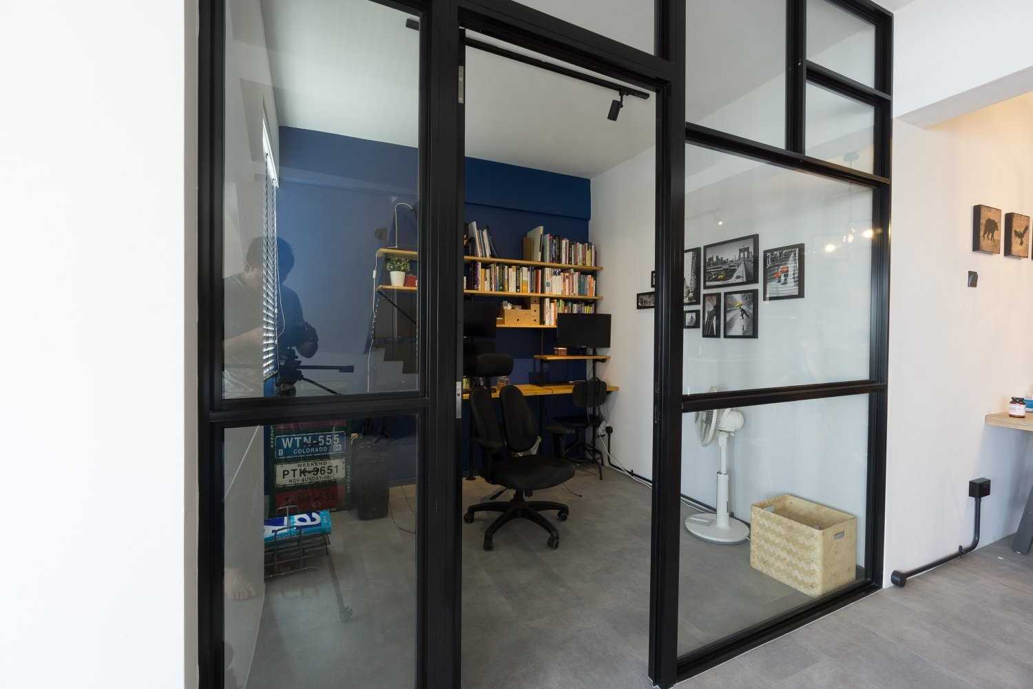 Industrial Home Office with Bookshelf and Desk Chairs
