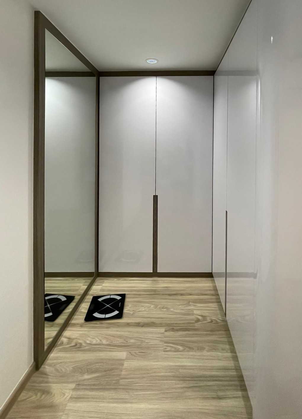 Modern Bedroom with Wood Flooring and Mirror