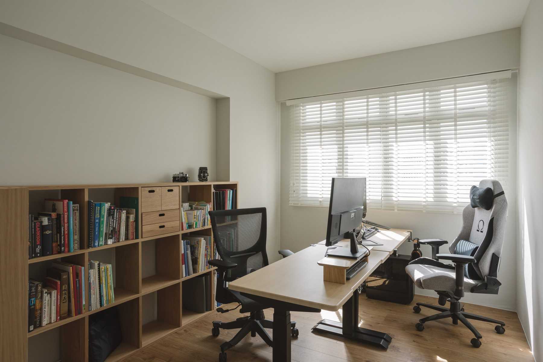 Modern Workstation with Bookshelf and Wood Flooring