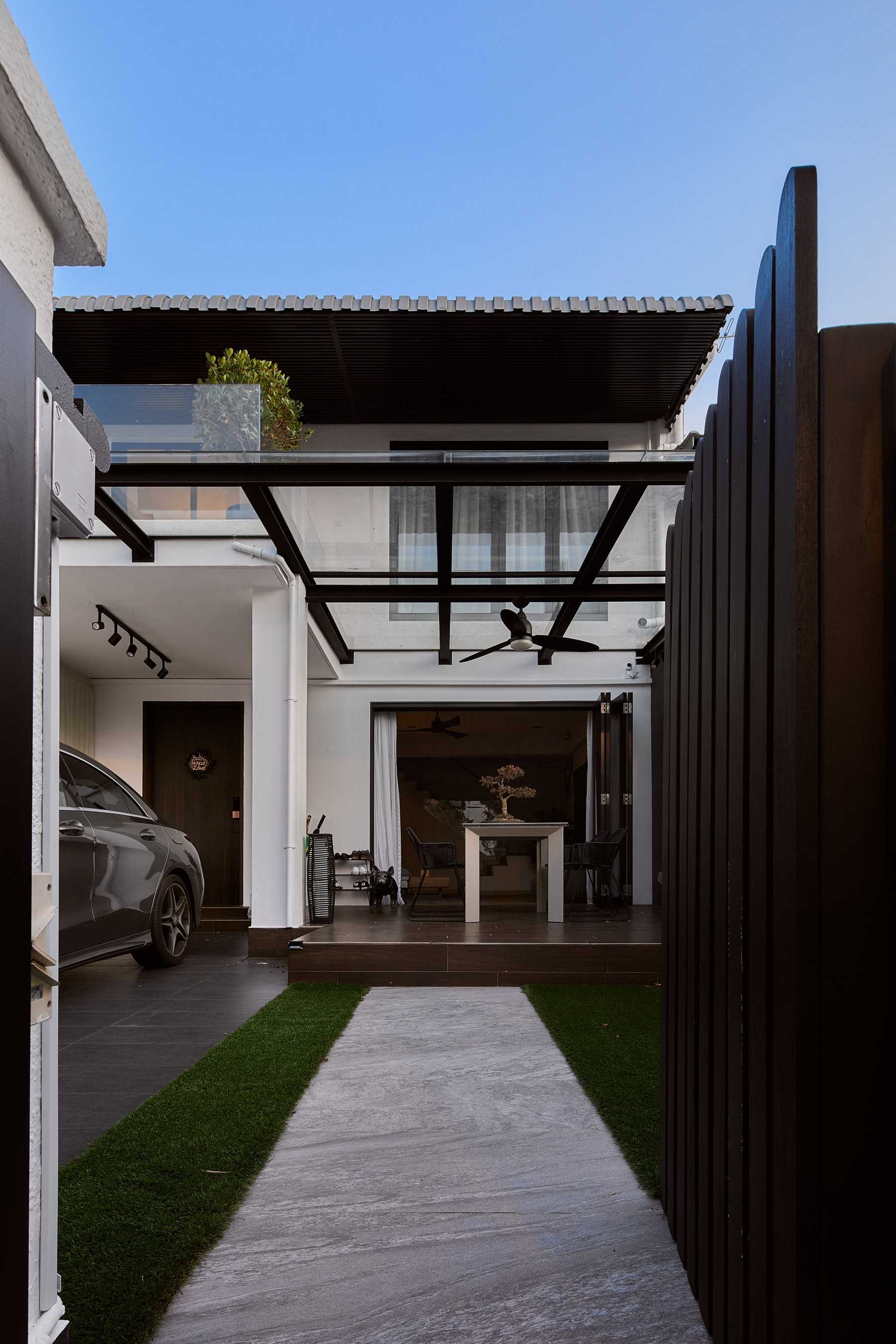 Modern Entryway with Ceiling Fan and Outdoor Table