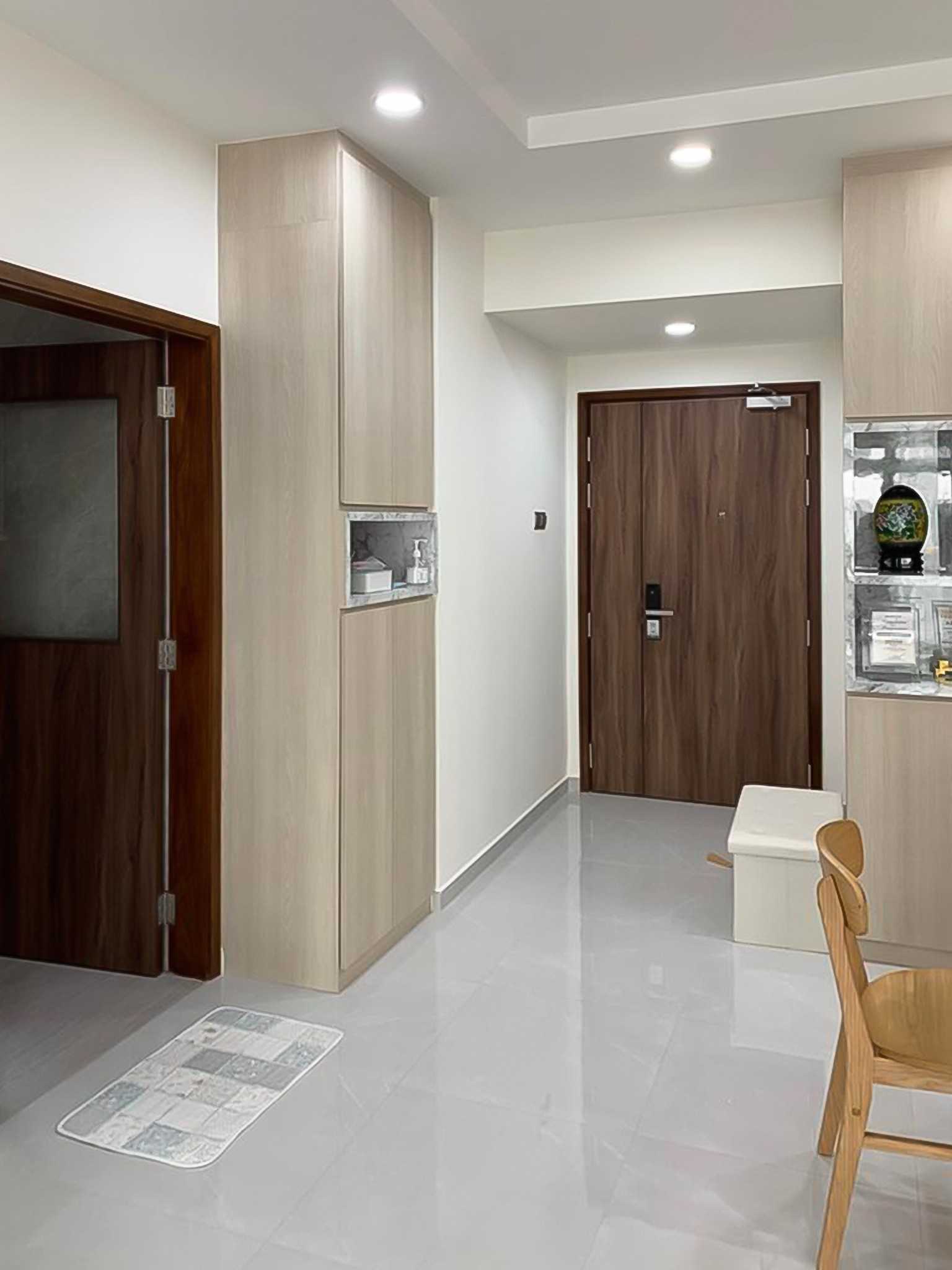 Scandinavian Foyer with Paintings and Storage Cabinets