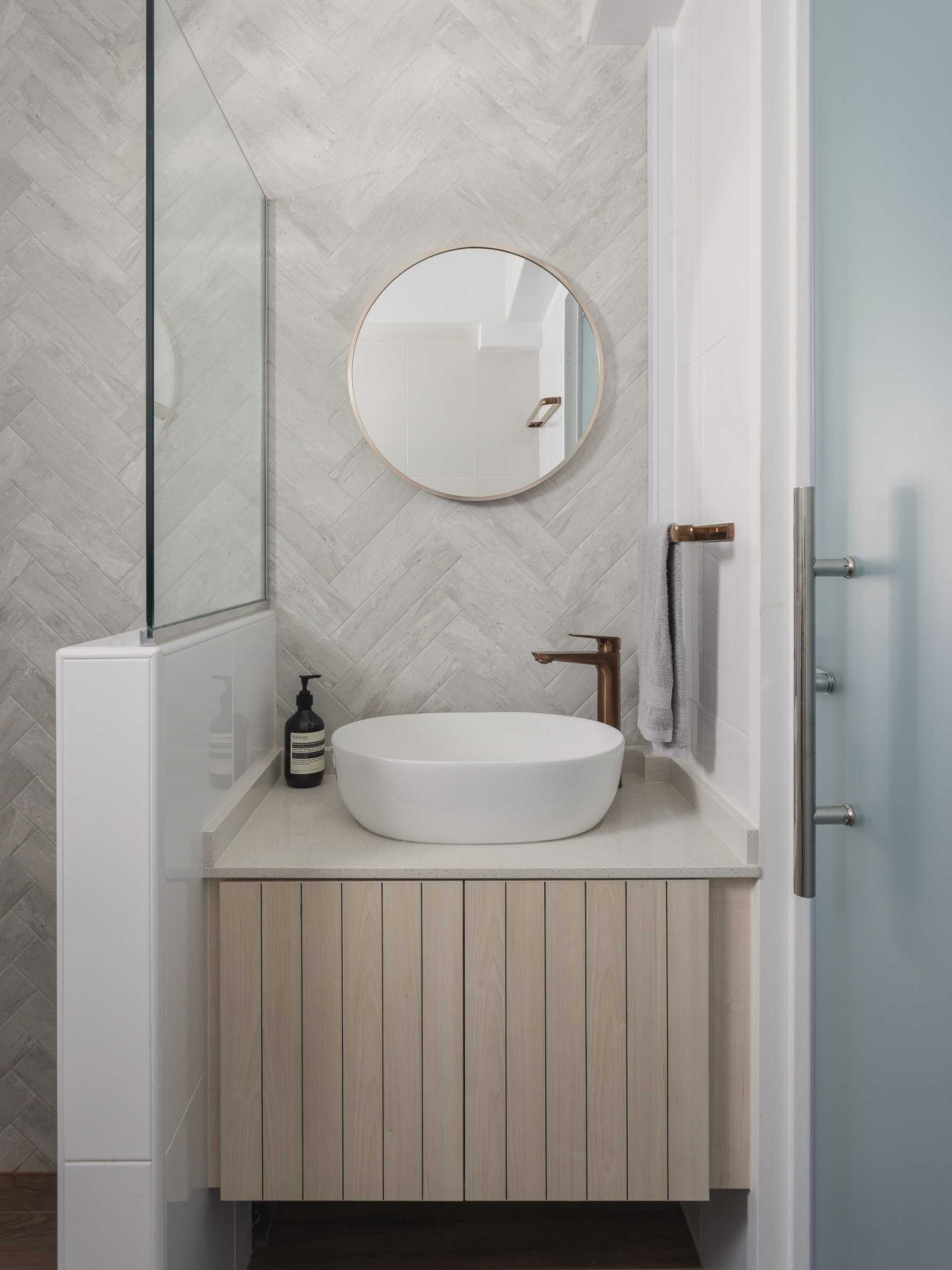 Scandinavian Bathroom with Herringbone Tiling and Mirror