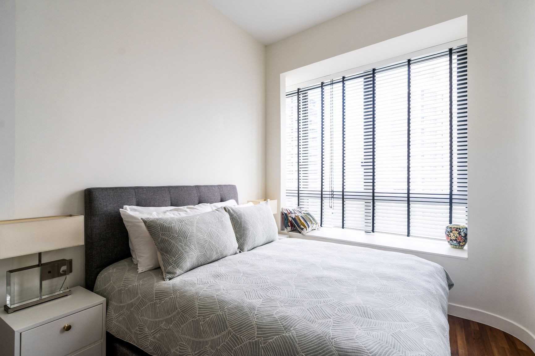 Modern Bedroom with Bay Window and Bedside Table