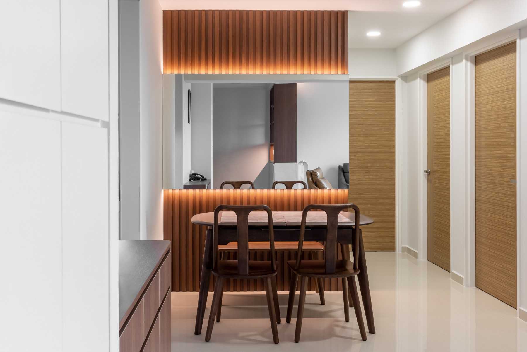 Transitional Dining Room with Feature Wall and Mirror