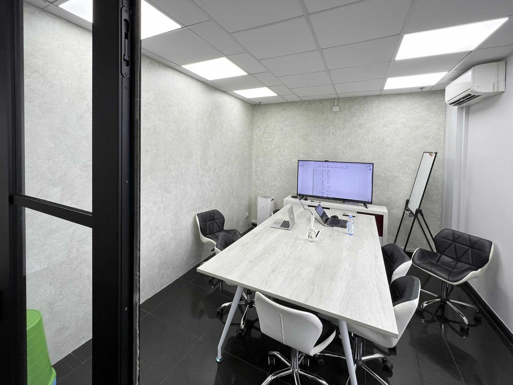 Modern Office with Glass Door and Paintings