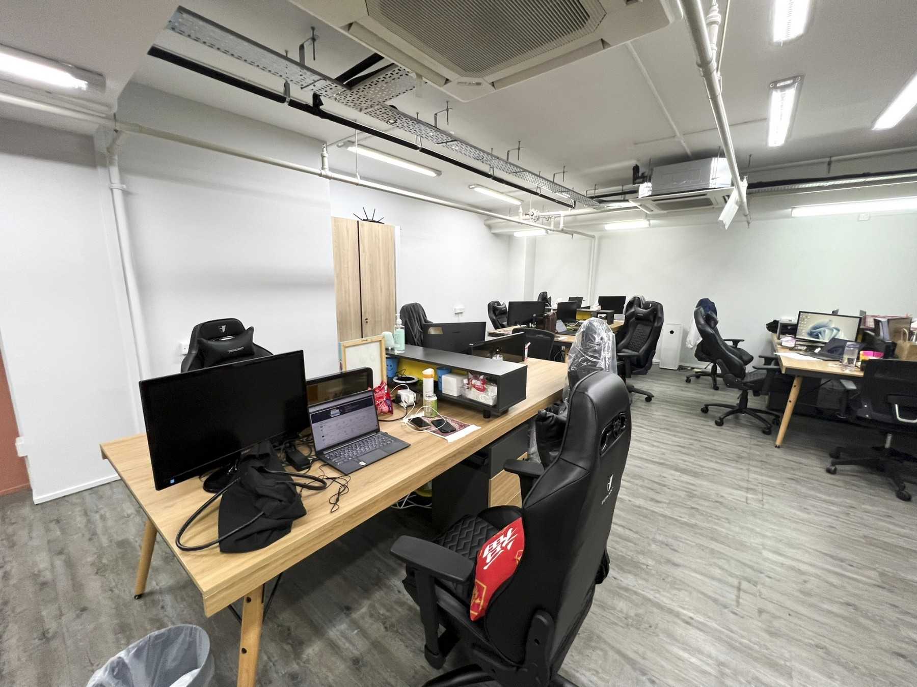 Modern Office with Paintings and Desk Chairs