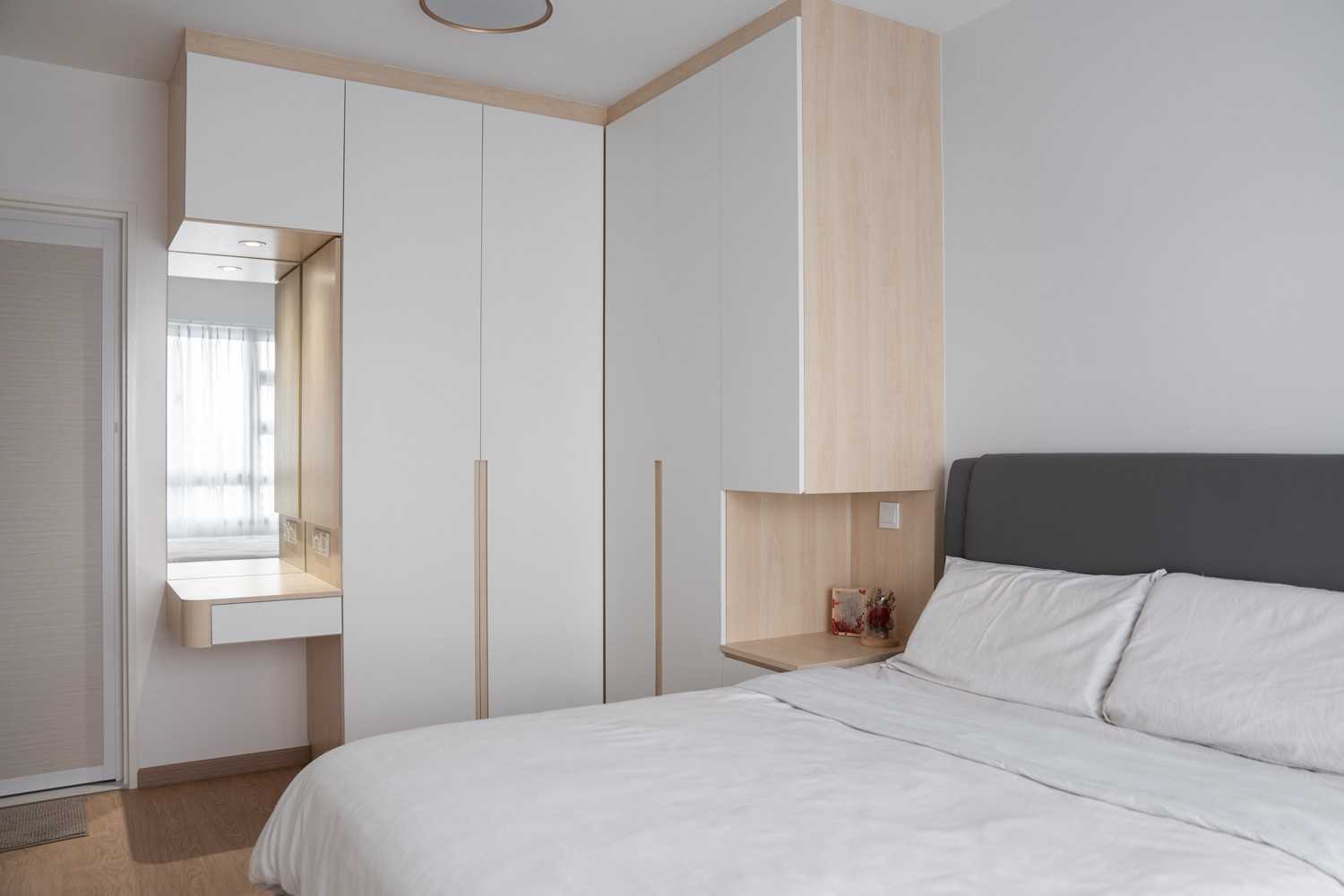Minimalist Bedroom with Wood Flooring and Wardrobe