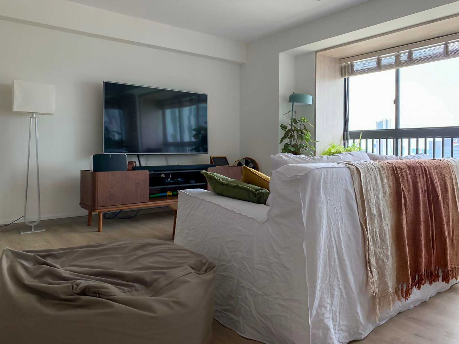 Scandinavian Living Room with TV Console and Window Seat