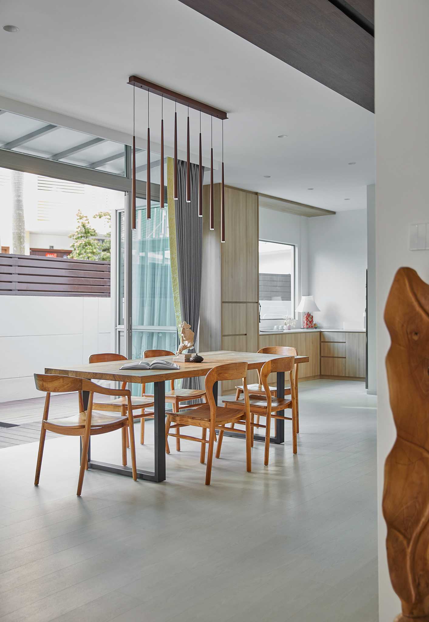 Scandinavian Dining Room with Glass Door and Paintings