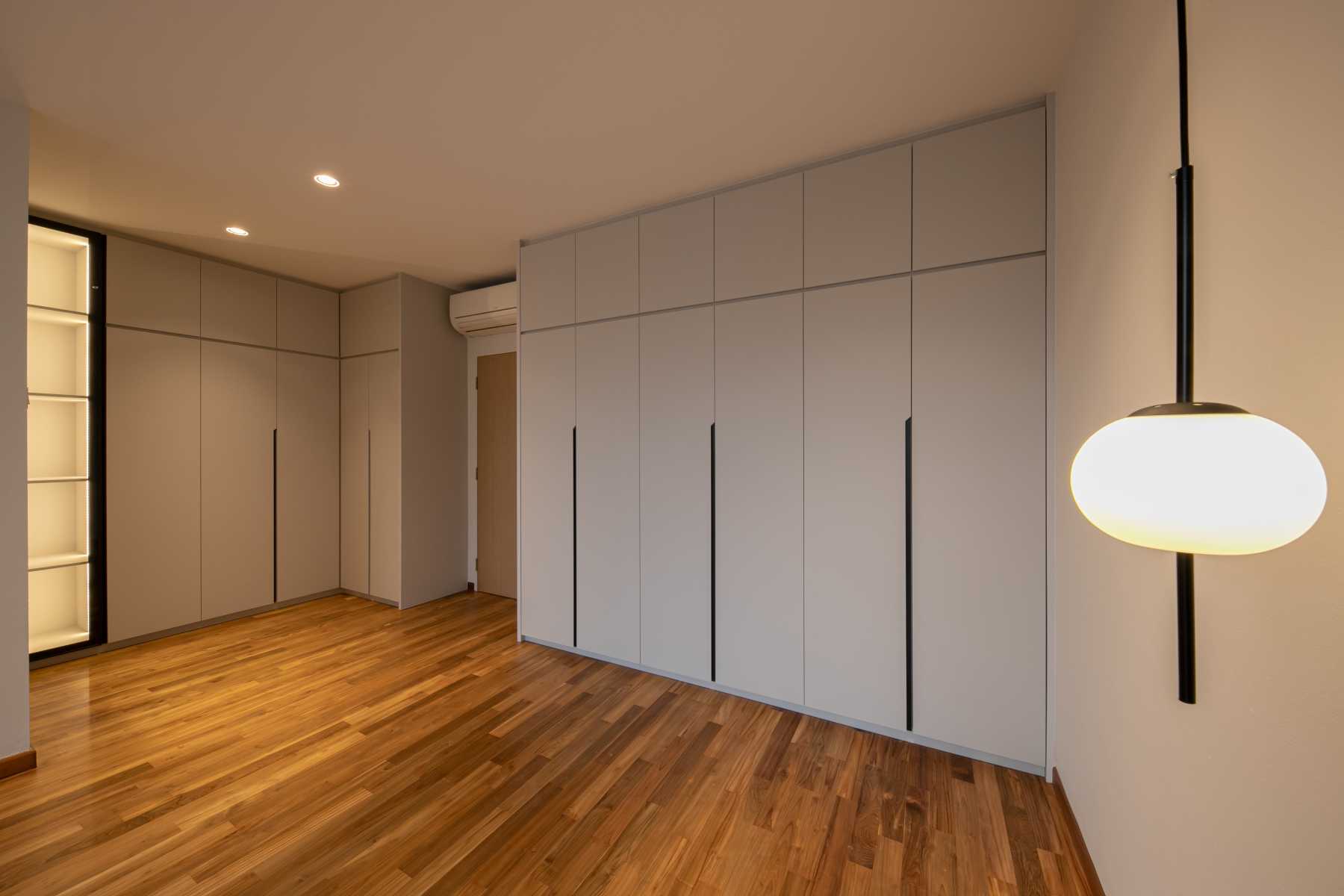 Minimalist Bedroom with Parquet Floor and Drop Light
