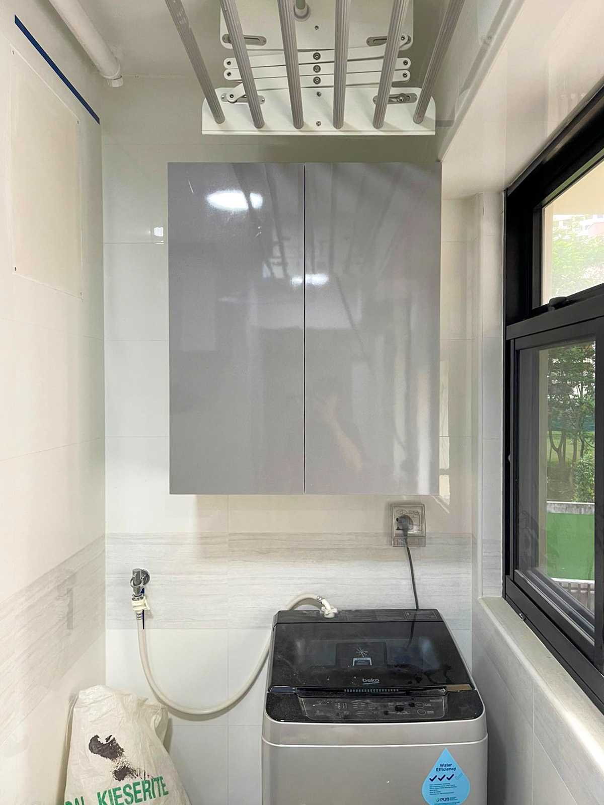 Minimalist Service Yard with Washing Machine and Laundry Area