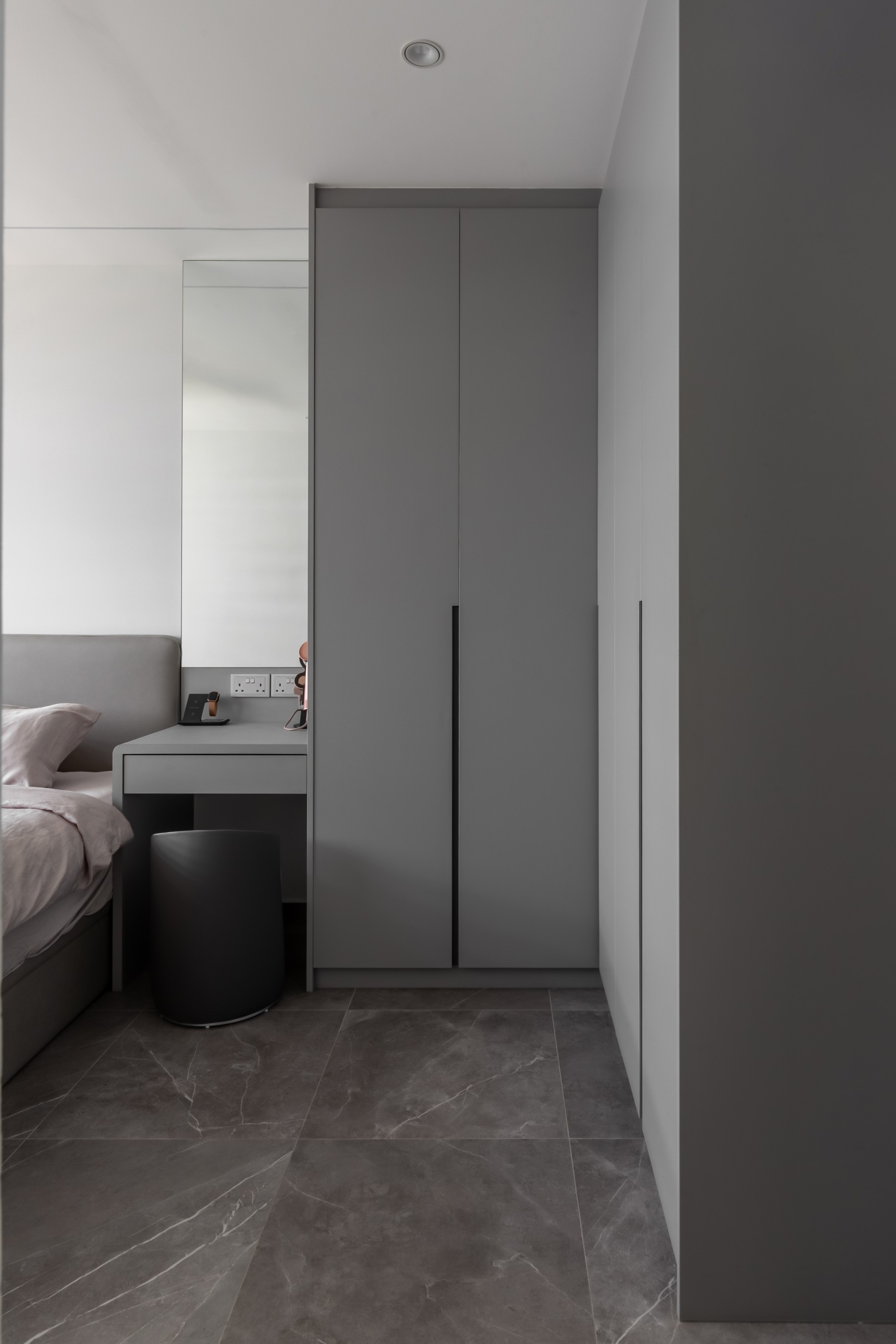 Minimalist Bedroom with Homogeneous Tiles and Wardrobe