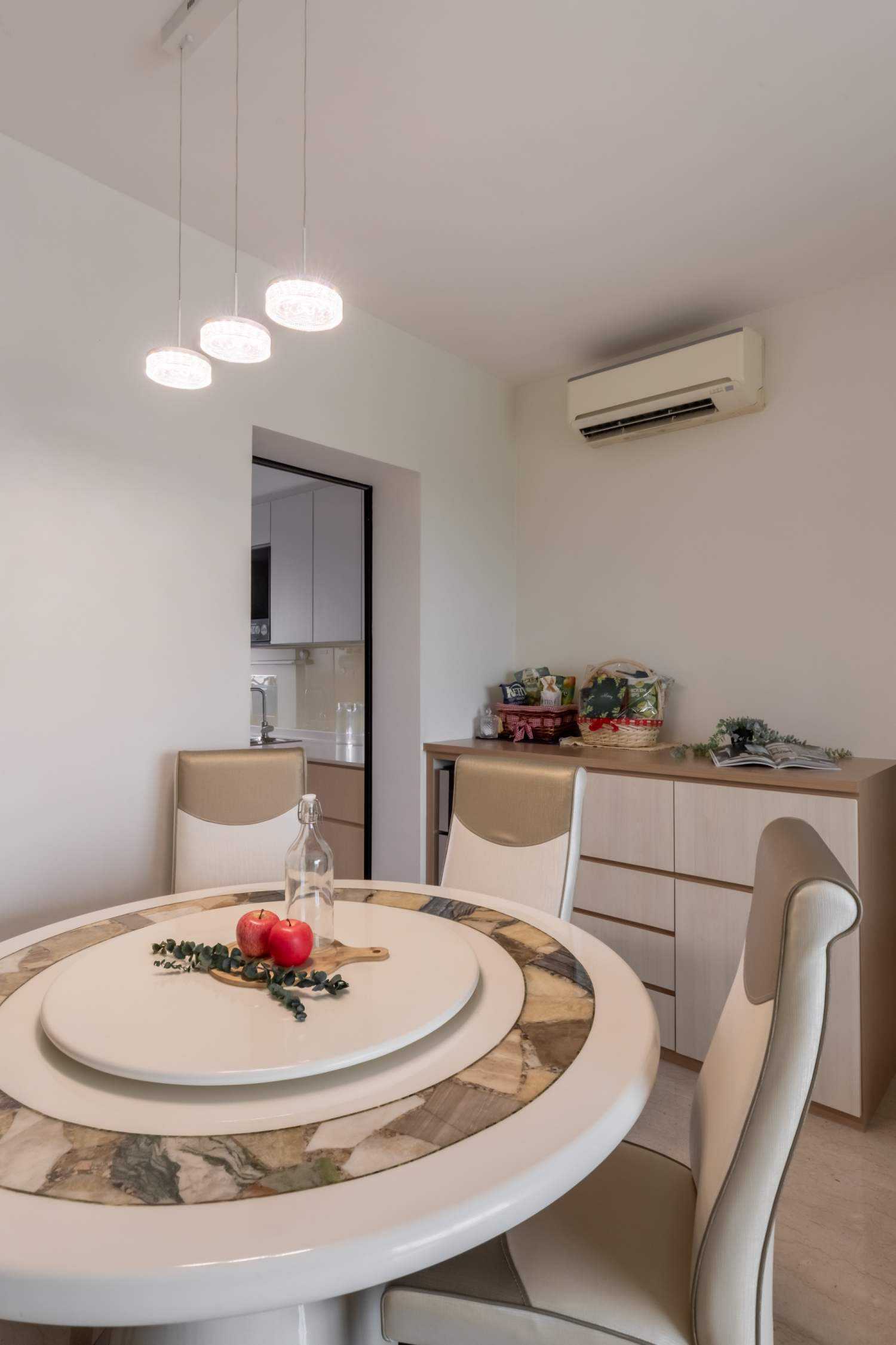 Minimalist Dining Room with Drop Light and Chandelier