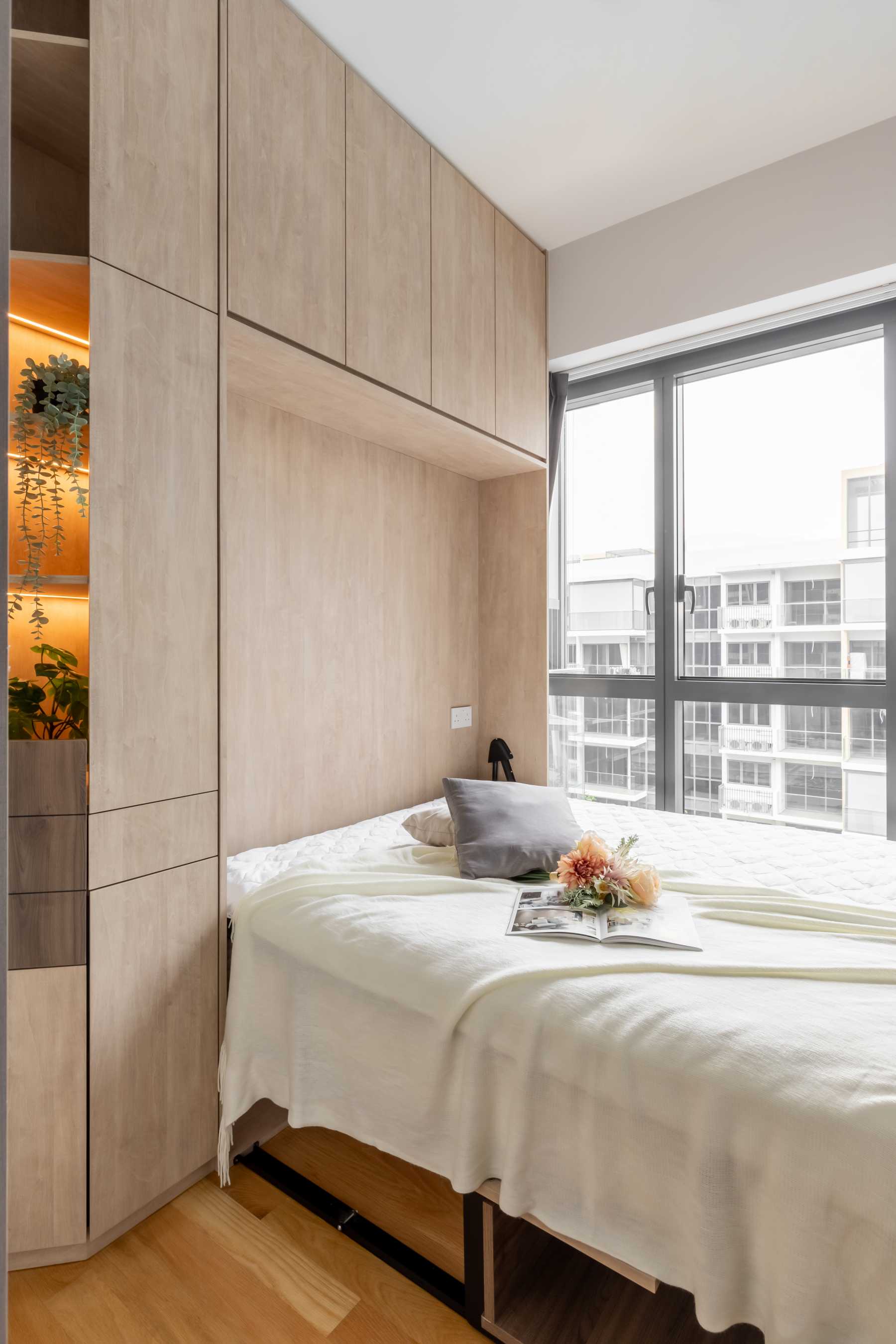 Modern Bedroom with Bay Window and Storage Cabinets