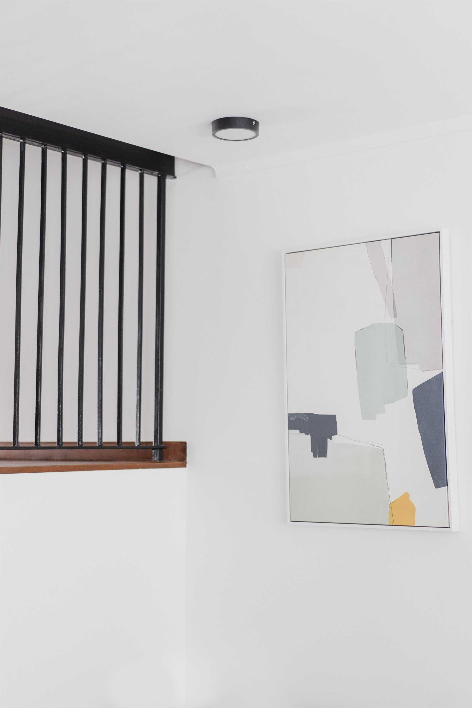 Contemporary Entryway with Ceiling Light and Paintings