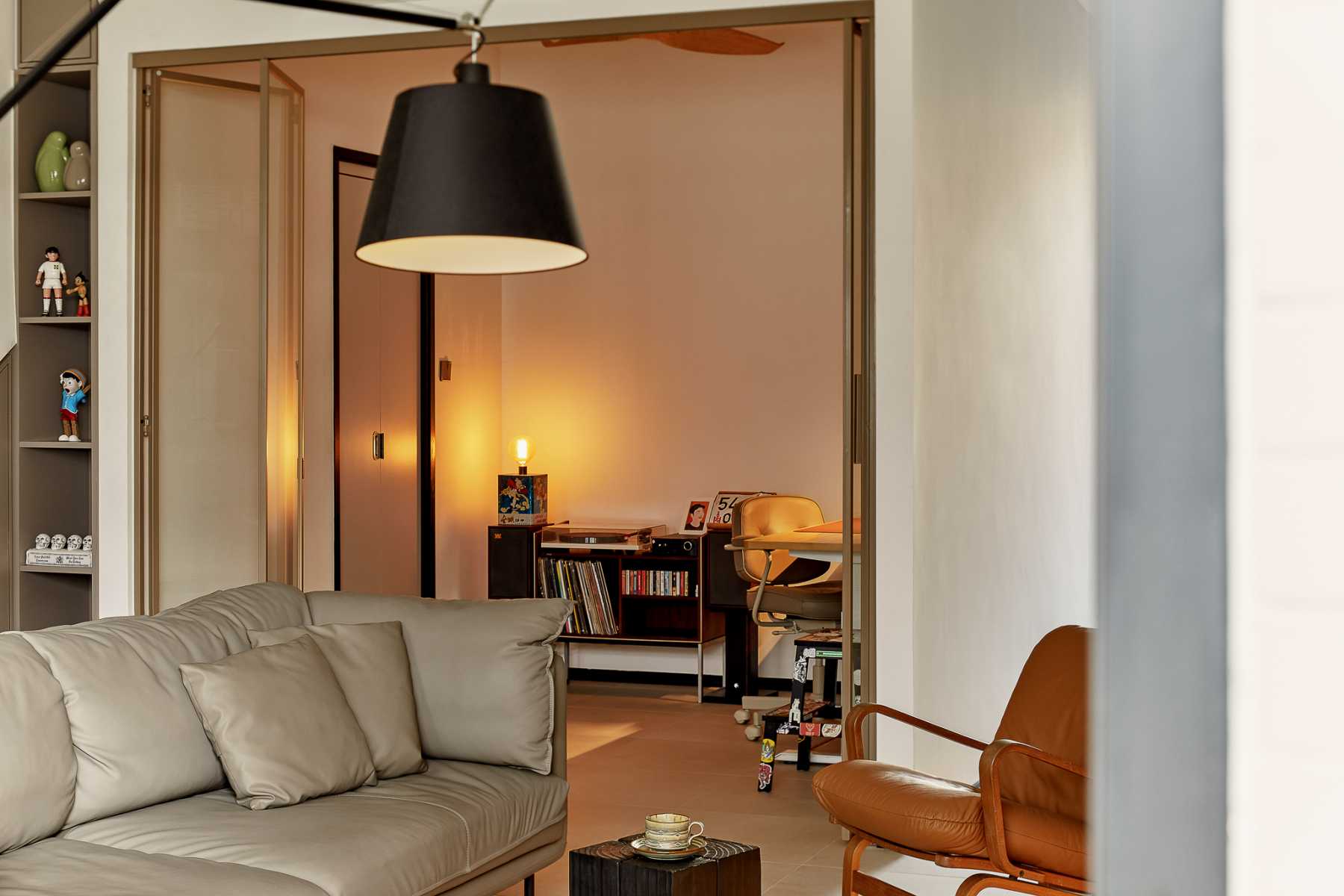 Eclectic Living Room with Drop Light and Sofa