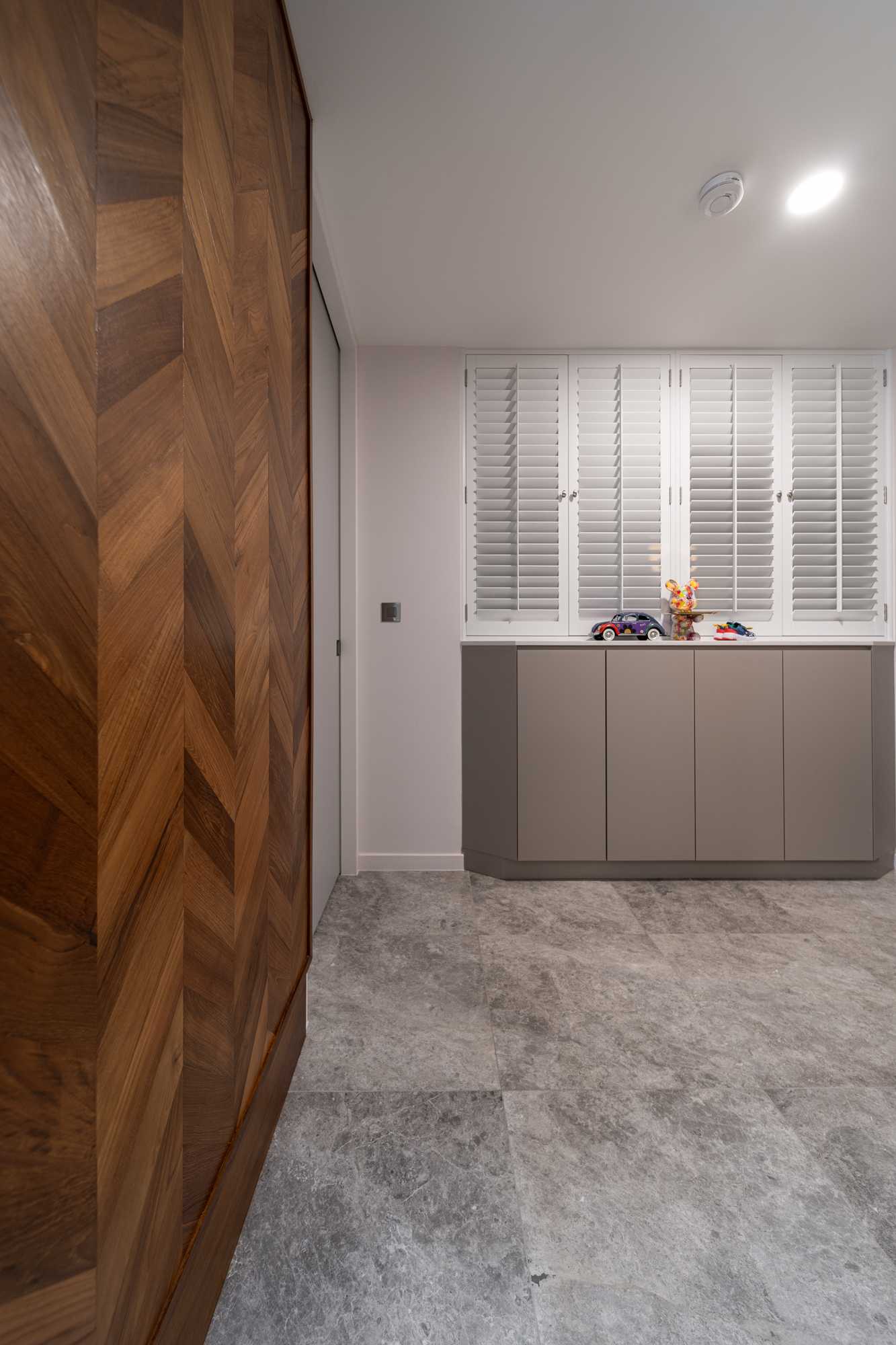 Modern Entryway with Granite Floor and Feature Wall