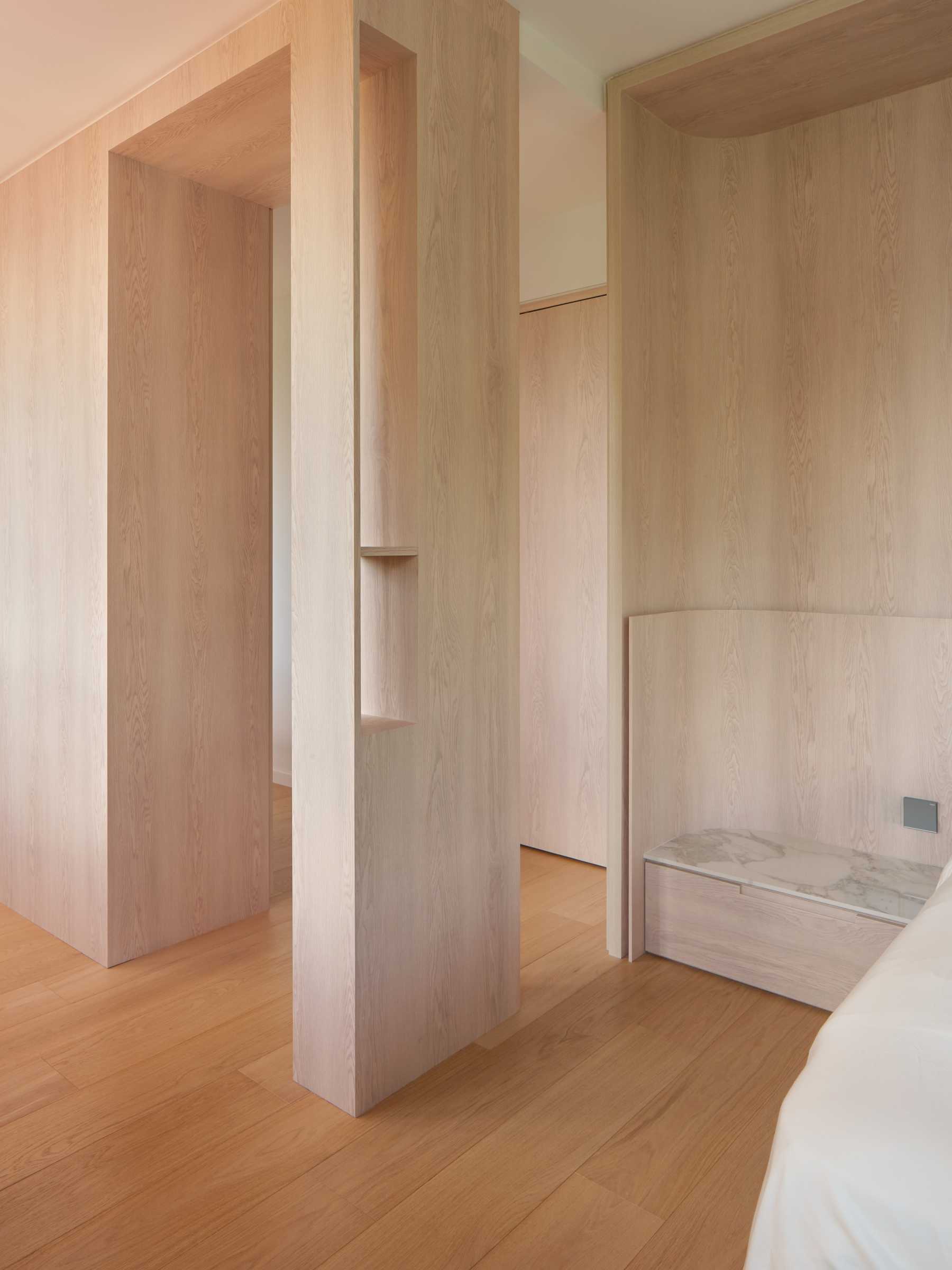 Minimalist Bedroom with Bookshelf and Parquet Floor