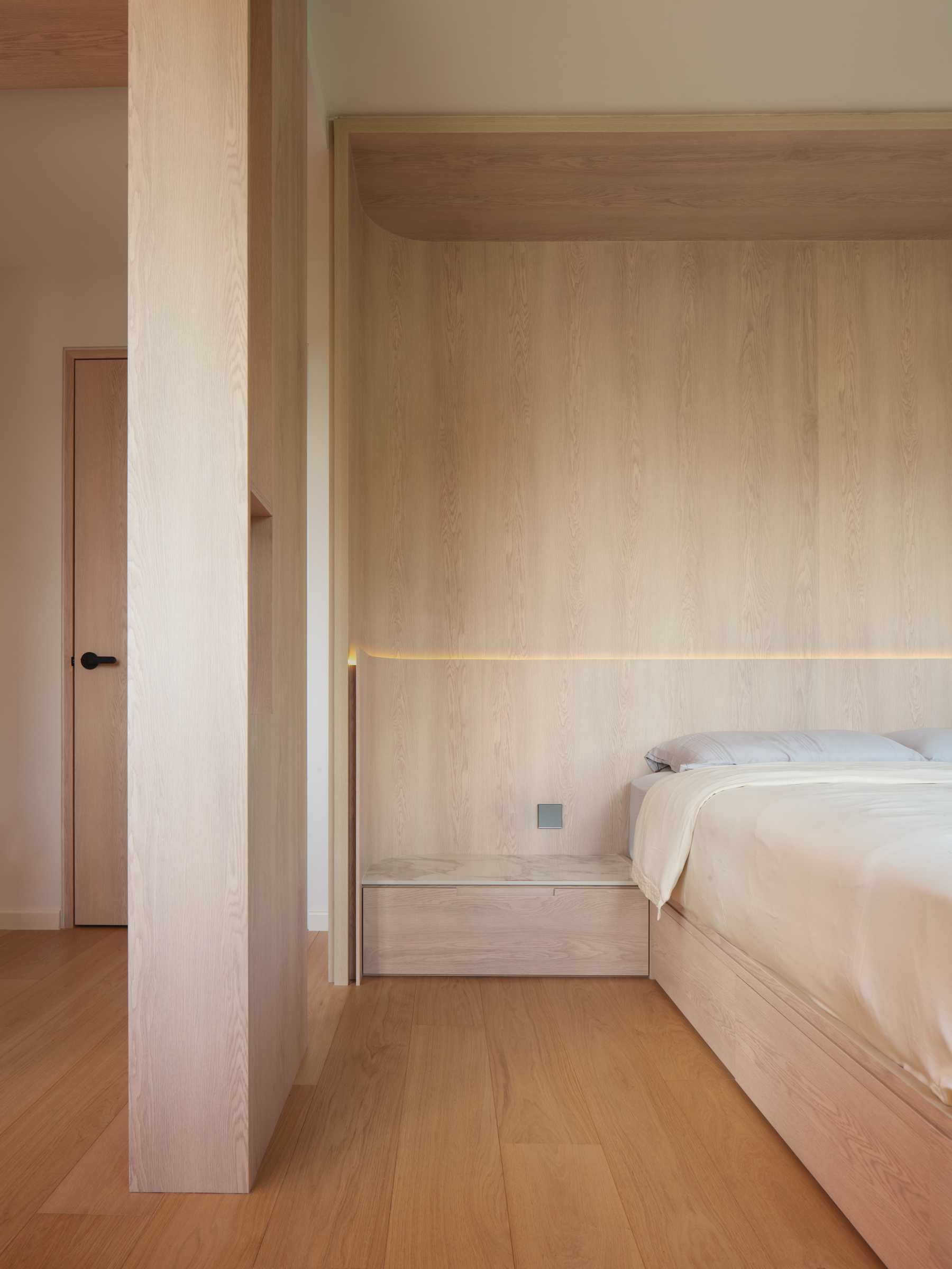 Minimalist Bedroom with Wood Flooring and Cove Lighting