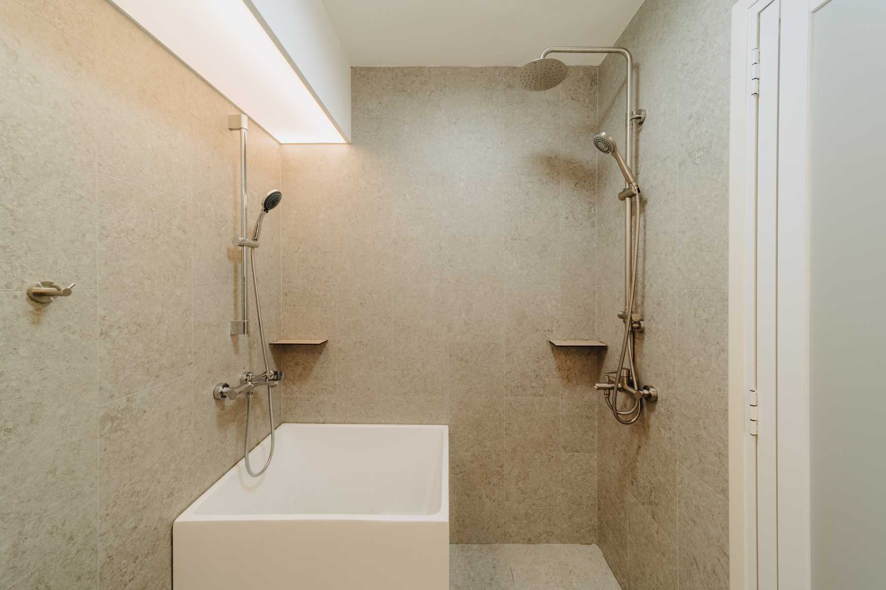 Modern Bathroom with Homogeneous Tiles and Bathtub