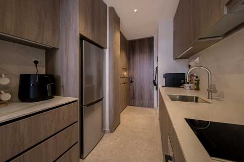 Contemporary Kitchen at 2 Bedroom Condo @ Parc Komo