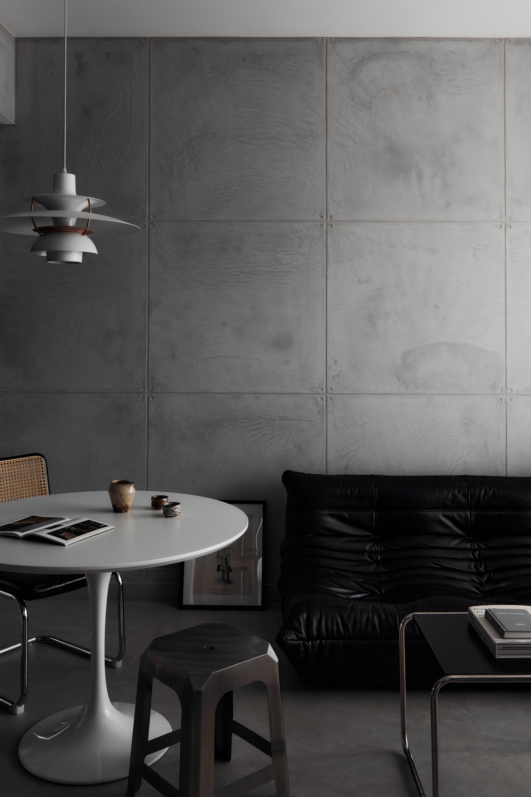 Industrial Living Room with Cement Floor and Feature Wall