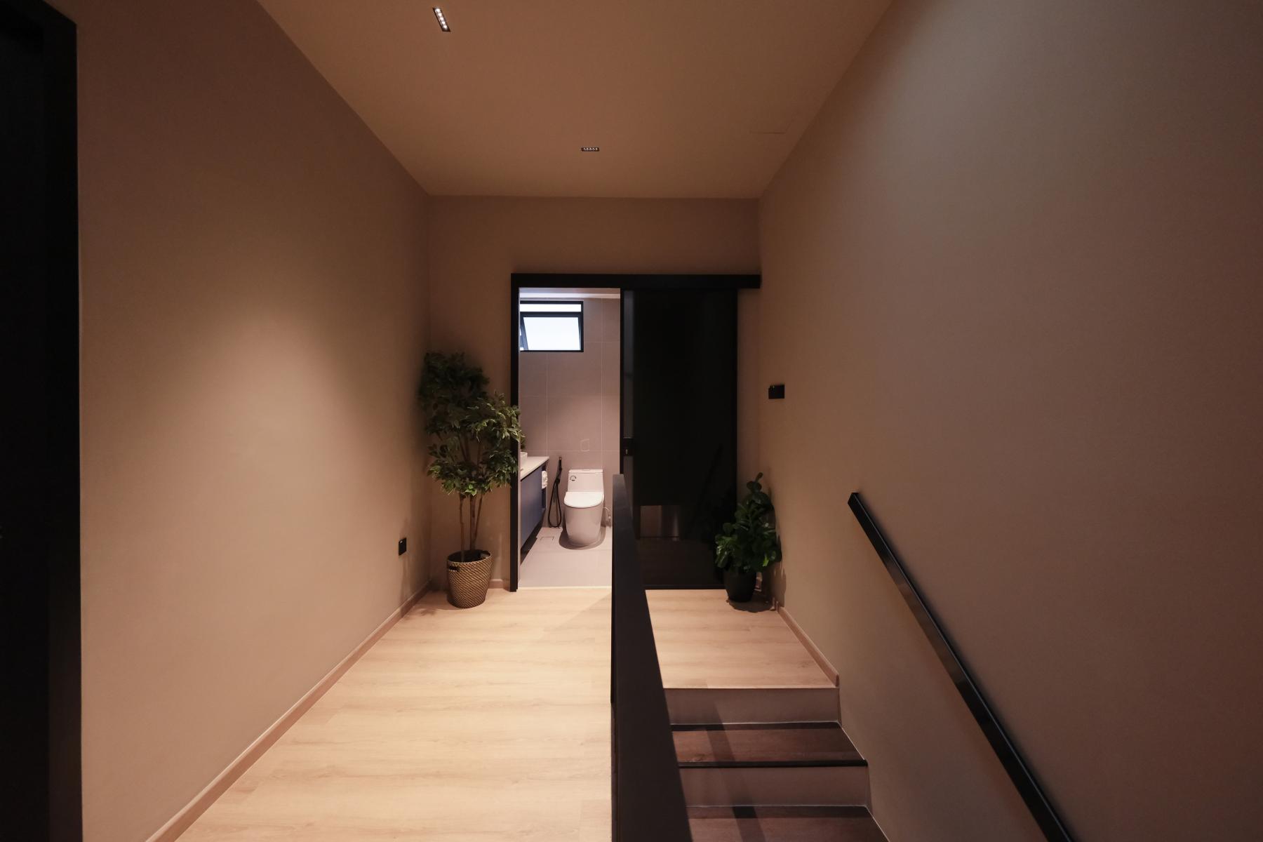 Contemporary Hallway with Bookshelf and Artwork