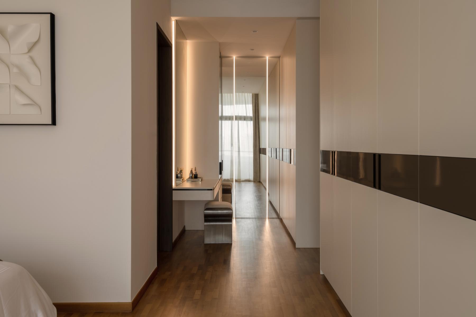 Contemporary Walk-in Wardrobe with Cove Lighting and Seating Bench