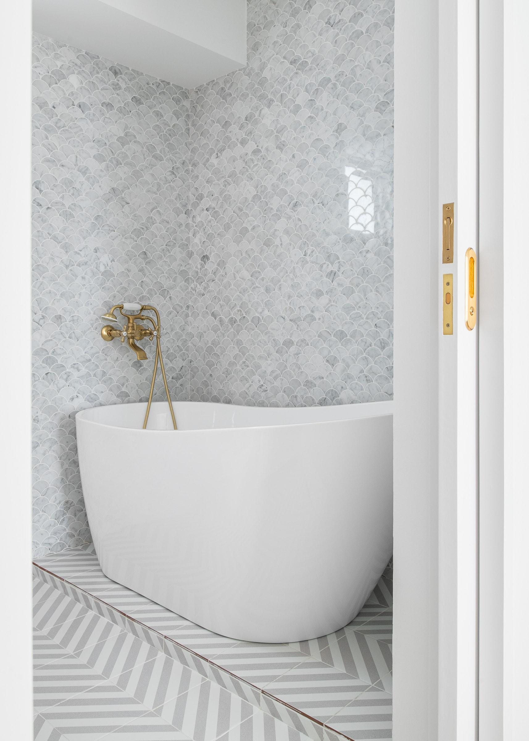 Minimalist Bathroom with Herringbone Tiling and Bathtub