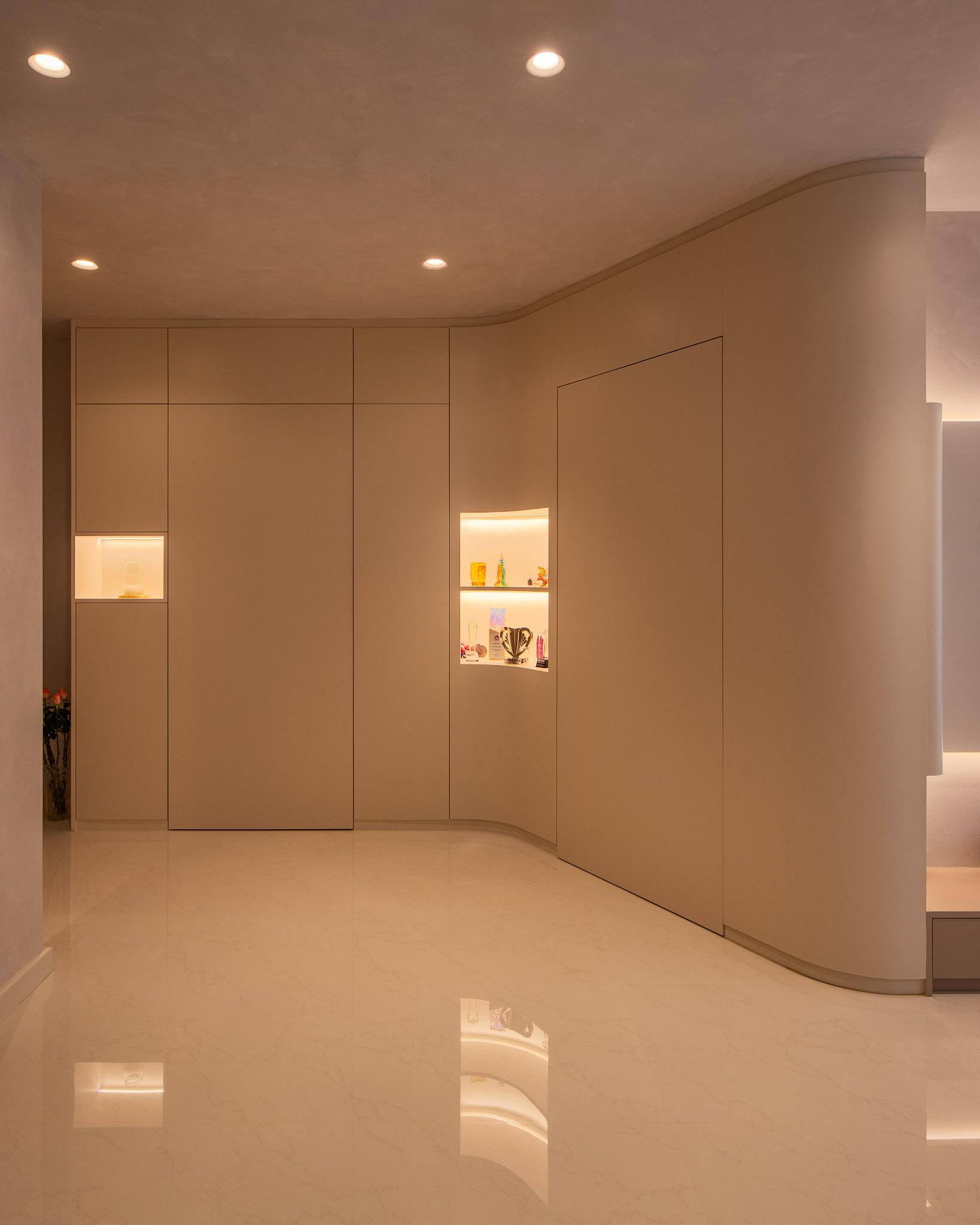 Minimalist Foyer with Cove Lighting and Downlights