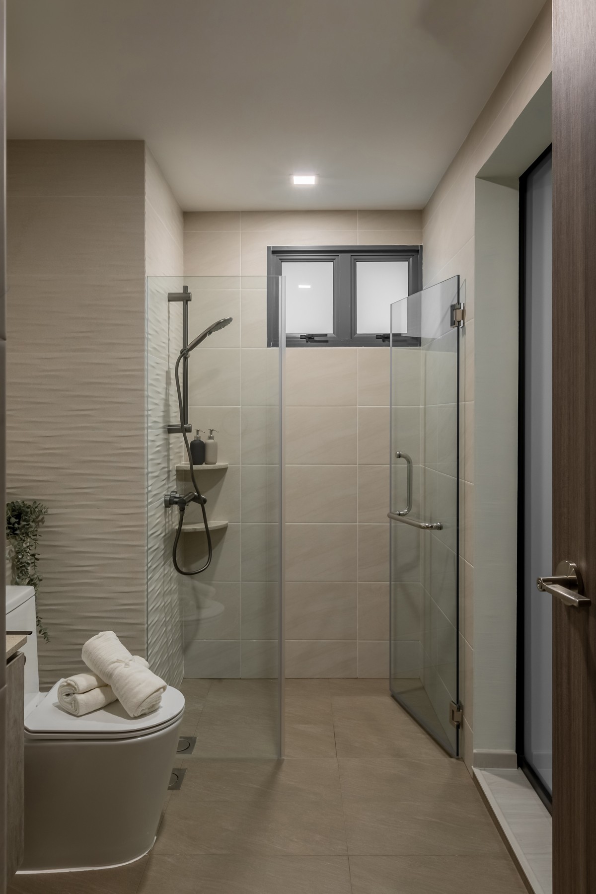 Modern Bathroom with Homogeneous Tiles and Glass Door