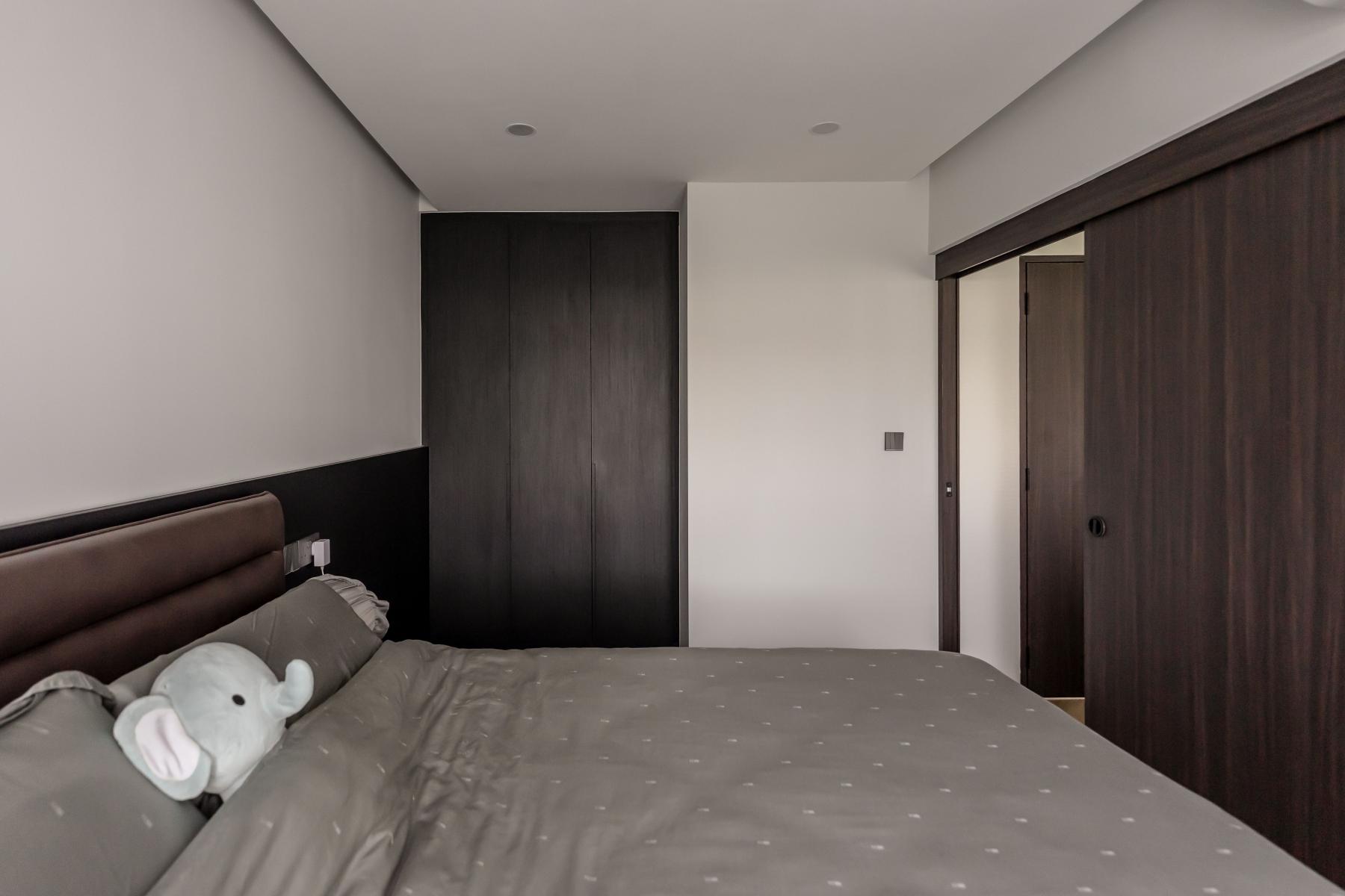 Contemporary Bedroom with Herringbone Tiling and Cove Lighting